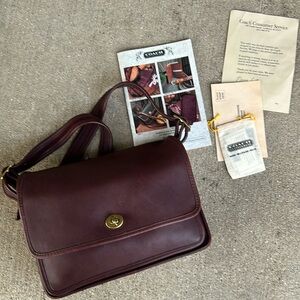 Coach burgundy spectator vintage purse. Comes with paperwork.